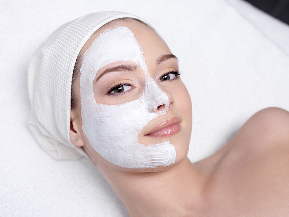 beautiful-young-woman-getting-facial-mask-beauty-salon-indoors